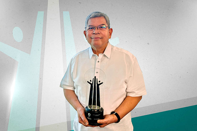 Mario Deriquito holding an award