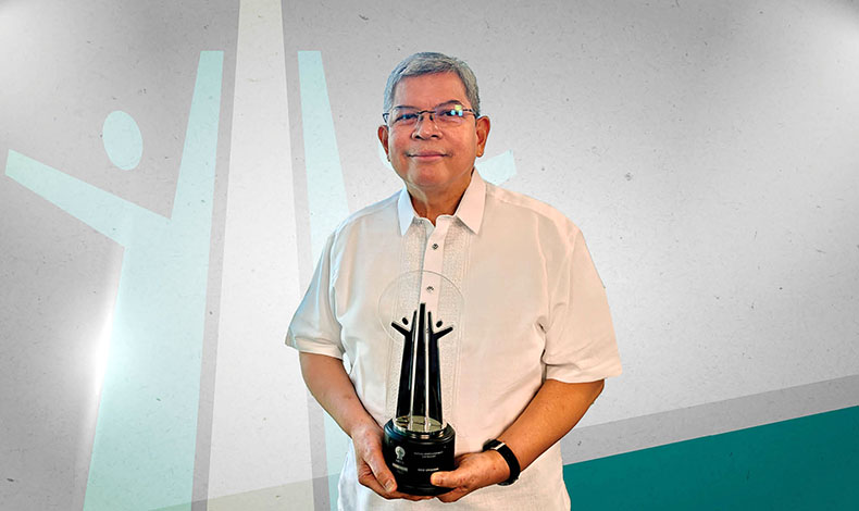 Mario Deriquito holding an award